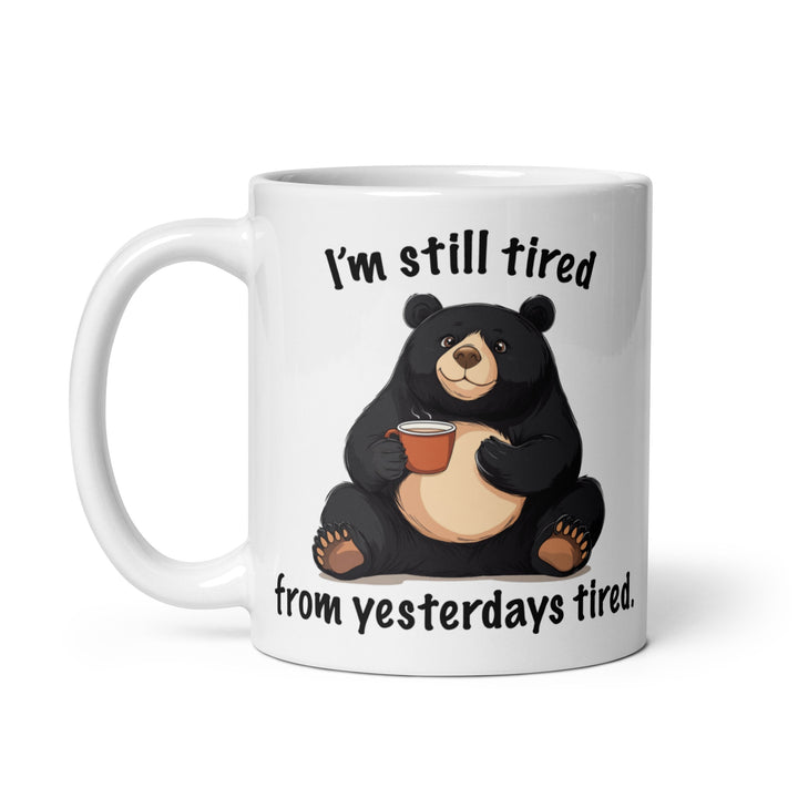 Funny Satire Coffee Mug featuring a bear holding a coffee cup with the quote I'm still tired from yesterdays tired