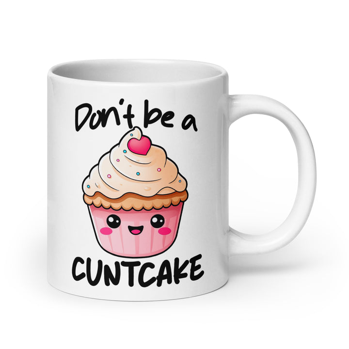 Funny Satire Coffee Mug featuring a cute cupcake graphic with the phrase Don't be a CUNTCAKE