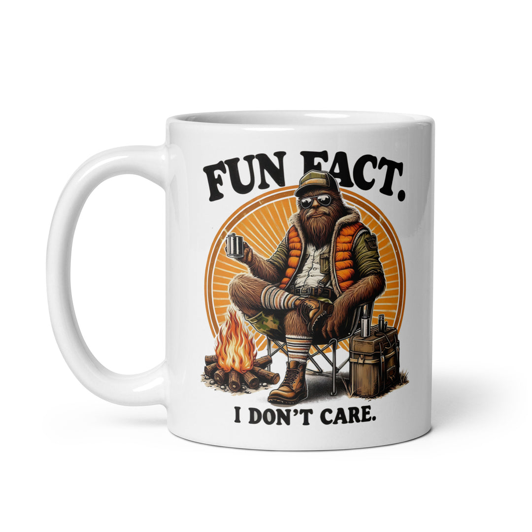 Funny Satire Coffee Mug featuring a relaxed character with a campfire and text saying Fun Fact. I Don't Care.