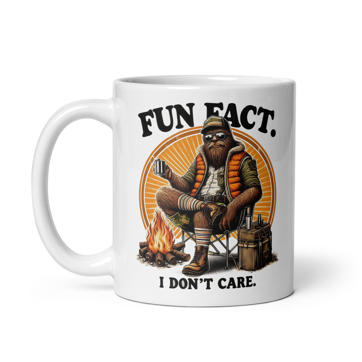 Funny Satire Coffee Mug featuring a relaxed character with a campfire and text saying Fun Fact. I Don't Care.