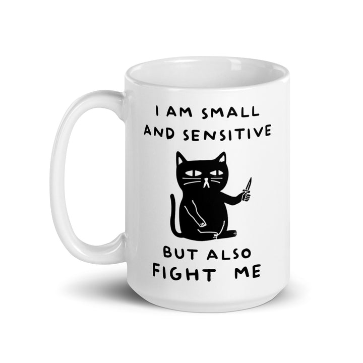 Funny Satire Coffee Mug featuring a cat holding a pen with the text I am small and sensitive but also fight me