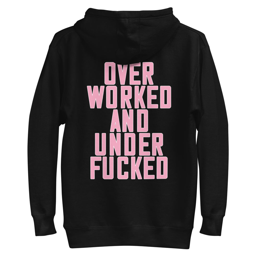 Black hoodie featuring bold pink text stating Over Worked and Under Fucked, ideal for Urban Streetwear Apparel style