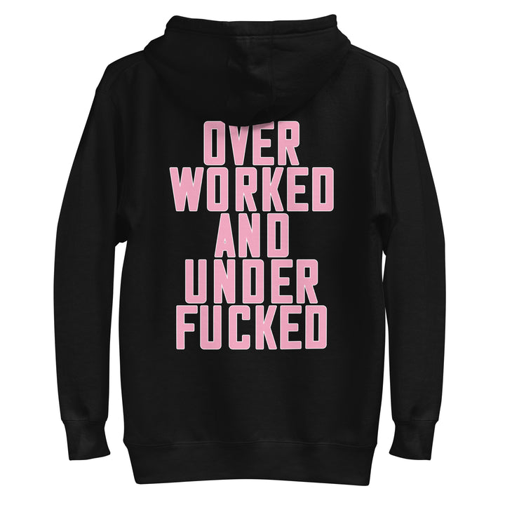 Black hoodie featuring bold pink text stating Over Worked and Under Fucked, ideal for Urban Streetwear Apparel style