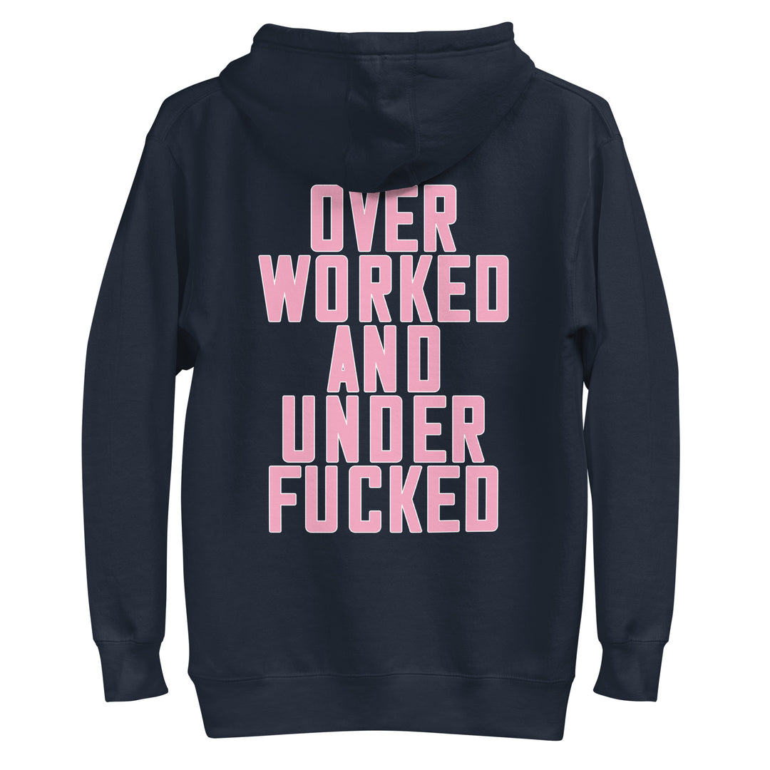 Navy hoodie with bold pink text reading Overworked and Underfucked, ideal for Urban Streetwear Apparel