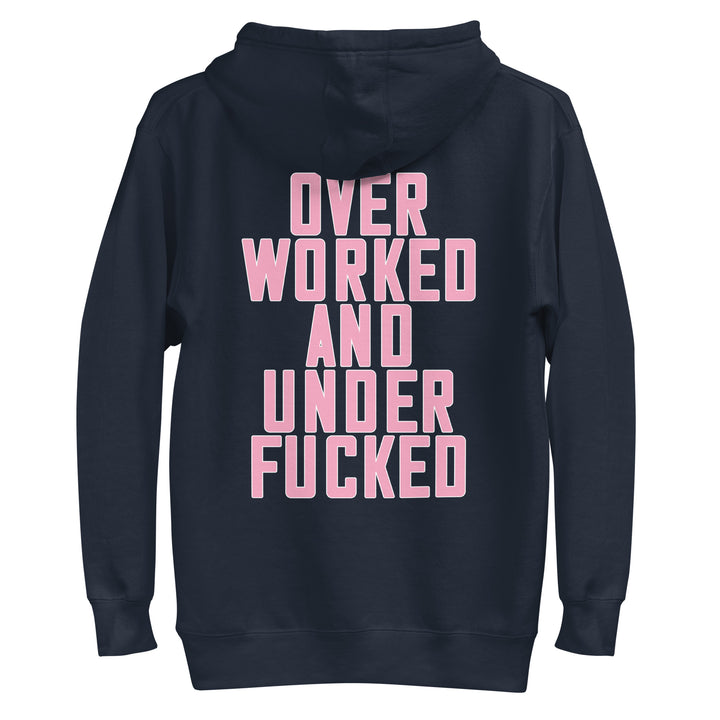 Navy hoodie with bold pink text reading Overworked and Underfucked, ideal for Urban Streetwear Apparel
