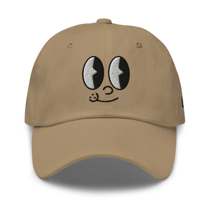 Tan cap with playful cartoon eyes and smile, perfect for Urban Streetwear Apparel enthusiasts